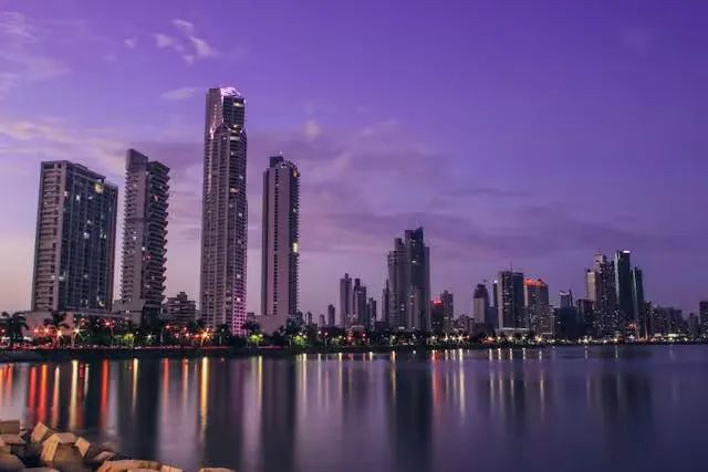 Stunning Panama City skyline reflecting on water at twilight, showcasing modern architecture.